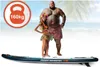 A large man and a small woman in Hawaiian attire stand on a paddleboard on a beach. Náhled obrázku produktu