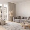 A modern living room with a gray sofa, a wooden coffee table, and a patterned rug. Anteprima dell’immagine prodotto
