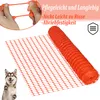 A rolled-up orange safety fence with a dog in the foreground and text overlays. Náhled obrázku produktu