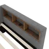 Close-up view of the headboard of a bed, showing built-in storage compartments and a USB charging port. Podgląd zdjęcia produktu