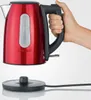A hand is holding a red electric kettle. Anteprima dell’immagine prodotto