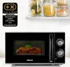 A black Medion microwave is shown on a countertop, with jars of pasta and grains on a shelf above. Produktbild-Vorschau
