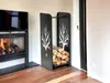 A modern living room with a fireplace and a black metal firewood rack with a tree design. Voir les images du produit