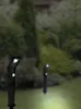 Two solar-powered garden lights are shown in a garden setting at dusk. Produktbild-Vorschau