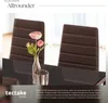 Two brown dining chairs are shown with a vase of pink flowers and a metallic candle holder on a dark table. The image is overlaid with text and a logo. Produktbild-Vorschau