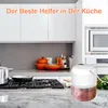 A modern kitchen counter with a food processor, pots, and utensils. Produktbild-Vorschau