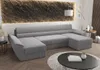 A U-shaped sofa in a modern living room setting with a textured wall and a coffee table. Náhled obrázku produktu
