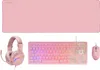 A pink gaming keyboard, mouse, headset, and XXL mousepad are laid out on a white background. Produktbild-Vorschau