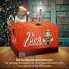 A Christmas-themed scene with a man in a Santa hat and a beer advent calendar. Produktbild-Vorschau