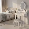 A bedroom scene with a vanity table and a bed. Voir les images du produit