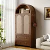 A wooden cabinet with woven doors and drawers, placed in a room next to a window and a sofa. Anteprima dell’immagine prodotto