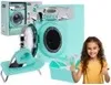 A young girl is giving a thumbs up next to a toy washing machine, laundry basket, and ironing board set. Podgląd zdjęcia produktu