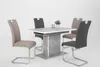 A dining table with four chairs in a studio setting. Produktbild-Vorschau