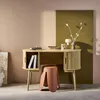 A modern wooden desk with a terracotta stool in a styled room. Produktbild-Vorschau