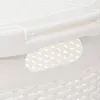 A close-up view of a white plastic laundry basket, showing the textured lid and a handle cutout with a perforated pattern visible through it. Podgląd zdjęcia produktu