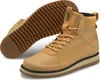 A pair of tan Puma boots are shown against a white background. One boot is upright and in focus, while the other is lying on its side, showing the sole. Podgląd zdjęcia produktu