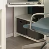 A close-up view of a desk with storage bins and a chair. Anteprima dell’immagine prodotto