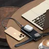 A Satechi Quatro Wireless Power Bank is charging an iPhone, AirPods, and an Apple Watch on a wooden table next to a laptop and a cup of coffee. Produktbild-Vorschau