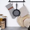 Kitchen items hanging on a rack, with jars and wooden slices on a counter. Produktbild-Vorschau
