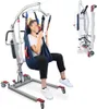 A woman is seated in a patient lift, which is a medical device used for transferring individuals. The lift is shown in a studio setting with a white background. Náhľad obrázku produktu