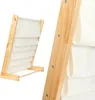 A close-up view of a wooden shelf organizer with fabric pockets. Anteprima dell’immagine prodotto