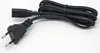 A black power cord with two different types of plugs on either end, laid out on a white background. Voir les images du produit