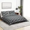 A bedroom scene with a bed, bedding, and a nightstand. Produktbild-Vorschau
