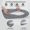 A person's hands are shown opening the zipper of a gray pillow, with icons and text describing its features. Podgląd zdjęcia produktu