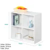 A white cube shelf with four compartments, decorated with books, a vase, and a deer figurine. A basket of fruit is on top. Produktbild-Vorschau