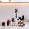 A collection of kitchen appliances, including a hand blender and its accessories, arranged on a countertop. Produktbild-Vorschau