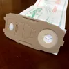A close-up shot of a vacuum cleaner bag on a wooden surface. Produktbild-Vorschau
