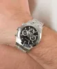 A close-up shot of a man's wrist wearing a silver Guess watch with a black face. Náhled obrázku produktu