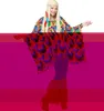 A woman wearing a psychedelic hippie poncho and headband. Produktbild-Vorschau