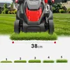 A lawnmower is shown in front of a grassy yard, with a measurement line indicating its cutting width and several samples of grass at different heights. Náhled obrázku produktu