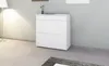 A white shoe cabinet is shown in a room with a floor lamp and a grey wall. Produktbild-Vorschau