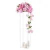 A tall, clear acrylic stand decorated with pink flowers and three white pillar candles at the base. Voir les images du produit