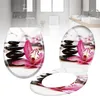 A toilet seat lid and seat with a design of stacked stones and a pink orchid. Produktbild-Vorschau