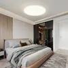 A modern bedroom with a bed, closet, and ceiling light. Voir les images du produit