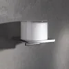 A soap dispenser on a shelf mounted on a textured gray wall. Produktbild-Vorschau