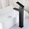 A black faucet is shown in a bathroom sink with water running. Náhľad obrázku produktu