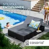 A man relaxing by a pool next to a lounge chair, with a woman walking in the background. Produktbild-Vorschau