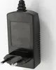 A black power adapter with European-style plug prongs. Produktbild-Vorschau