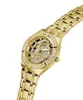 A close-up, angled view of a gold-colored Guess women's watch with diamond accents on a white background. Náhľad obrázku produktu