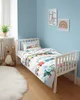 A child's bedroom with a bed, teddy bear, and wall art. Produktbild-Vorschau