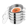 A stainless steel steamer with multiple layers and a glass lid, containing cooked shrimp on a plate. Voir les images du produit