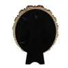 The back of a gold-colored oval picture frame with a stand. Anteprima dell’immagine prodotto