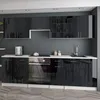 A modern, high-gloss black kitchen unit with a white countertop, featuring integrated appliances and overhead cabinets. Náhled obrázku produktu