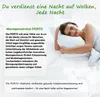 A woman is lying on a bed with a pillow, smiling. Produktbild-Vorschau