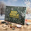 A collection of mini-games and a mini-games advent calendar are displayed on a wooden table in a winter setting with bokeh lights in the background. Produktbild-Vorschau