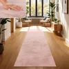 A hallway with a pink runner rug, two chairs, plants, and a wooden cabinet. Voir les images du produit